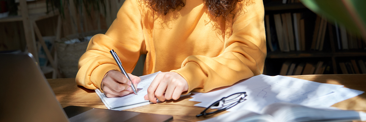 A student working on writing for a college application essay